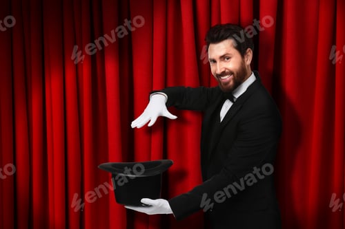 Preview: Magician performing trick with top hat on stage with red curtains