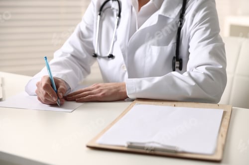 Preview: Doctor writing on sheet of paper at table in clinic, closeup