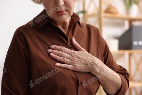 Preview: Heart attack. Senior woman suffering from pain in chest indoors, closeup