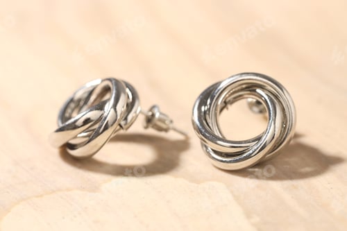 Preview: Beautiful silver earrings on light background, closeup