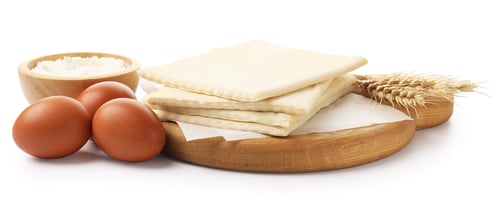 Preview: Raw puff pastry dough, flour, eggs and spikes isolated on white