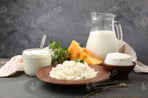 Preview: Different dairy products and parsley on black wooden table, closeup