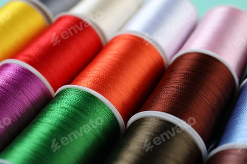 Preview: Spools of sewing threads as background, closeup