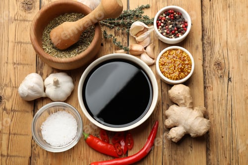 Preview: Soy sauce and other different ingredients for marinade on wooden table, flat lay