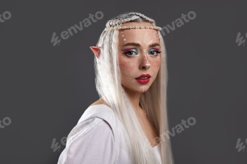 Preview: Beautiful girl dressed as elf on grey background