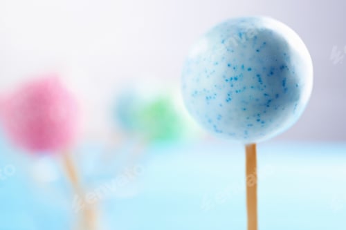 Preview: Tasty cake pops on blurred background, selective focus. Space for text