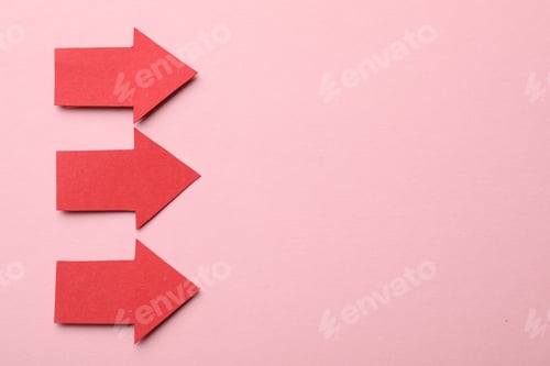 Preview: Red paper arrows on pink background, flat lay. Space for text