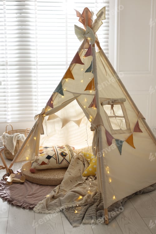 Preview: Cute wigwam with fairy lights and toys in stylish child's room