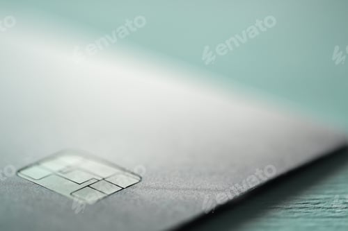 Preview: One credit card on turquoise background, macro view