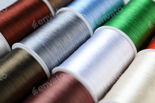 Preview: Spools of sewing threads as background, closeup