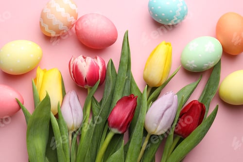 Preview: Painted Easter eggs and beautiful tulips on pink background, flat lay