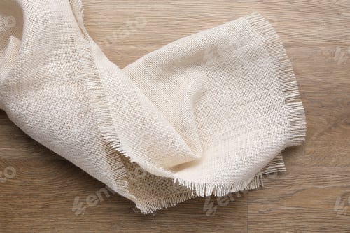 Preview: Natural burlap fabric on wooden table, top view