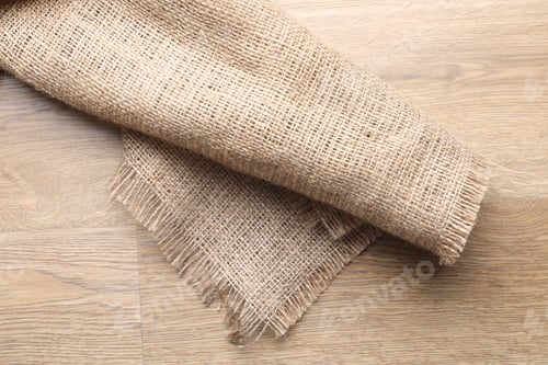 Preview: Natural burlap fabric on wooden table, top view