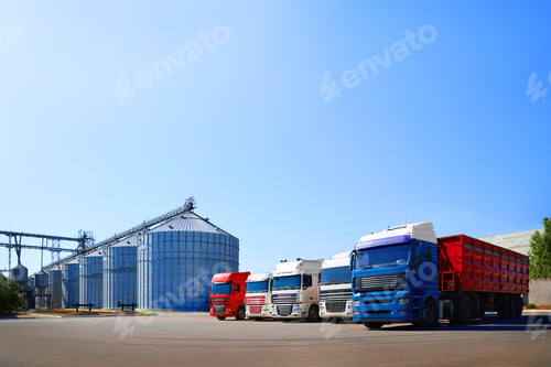 Preview: Modern granaries for storing cereal grains and trucks outdoors