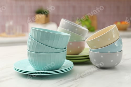 Preview: Different clean dishware on white table in kitchen, closeup