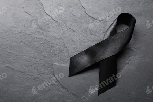 Preview: Black awareness ribbon on dark table, top view. Space for text