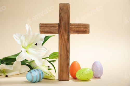Preview: Easter. Wooden cross, painted eggs and beautiful lily flower on beige background, closeup
