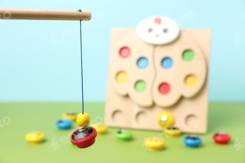 Preview: Sorting set for children with wooden fishing rod and magnetic figure against blurred color backgroun