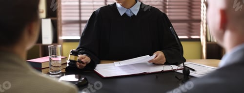 Preview: Judge in court dress working at desk indoors, selective focus