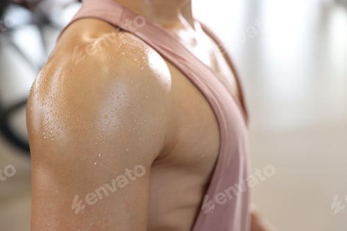 Preview: Man with sweat on his body in gym, closeup. Space for text