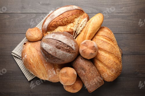 Preview: Different types of bread and spikes on wooden table, top view