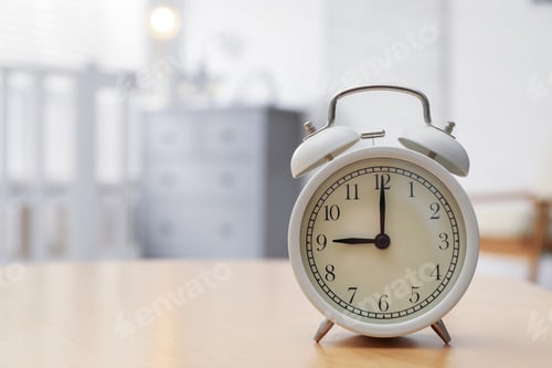 Preview: Alarm clock on table in nursery, closeup. Space for text