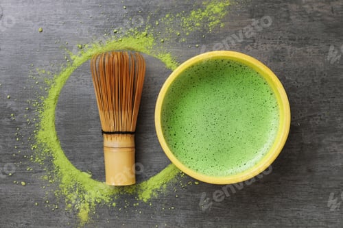 Preview: Refreshing green matcha in ceramic bowl, bamboo whisk and powder on gray textured table, flat lay