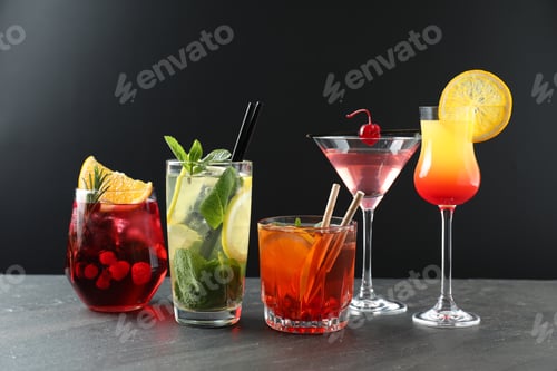 Preview: Different tasty refreshing cocktails on grey table