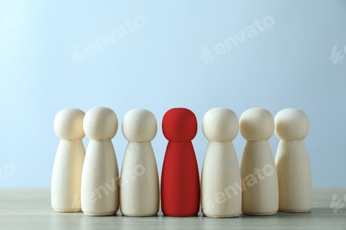 Preview: Dismissal. Red figure among wooden ones on table
