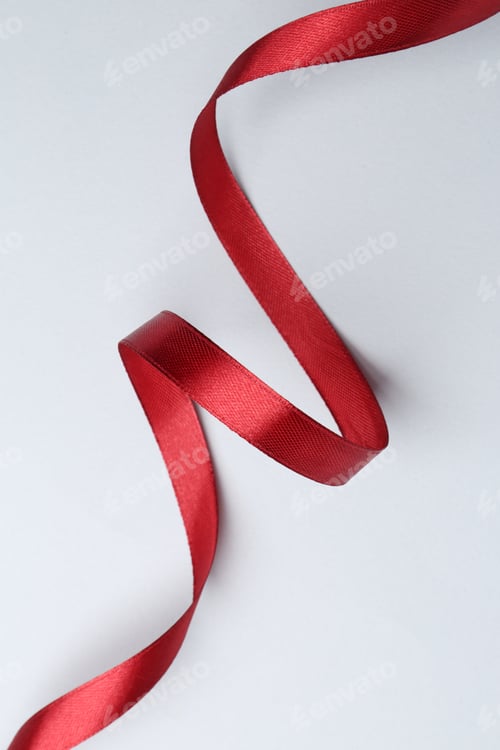 Preview: Beautiful red ribbon on light background, top view