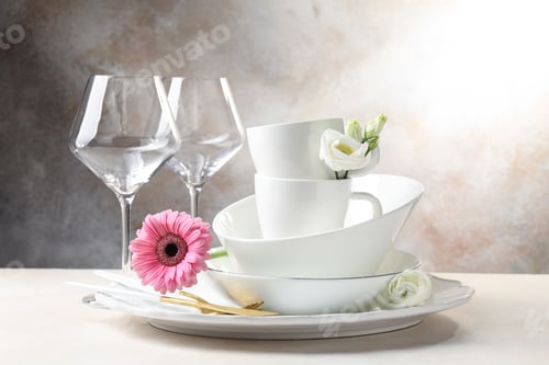 Preview: Clean dishware and beautiful flowers on light table