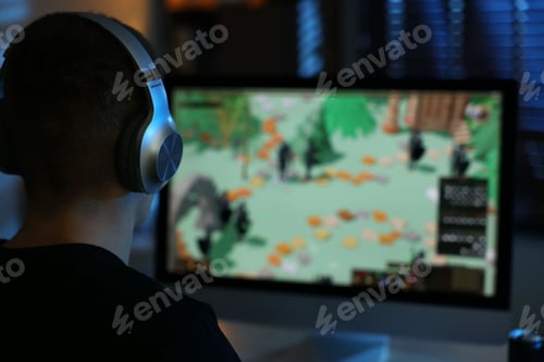 Preview: Man playing video games on computer at table indoors