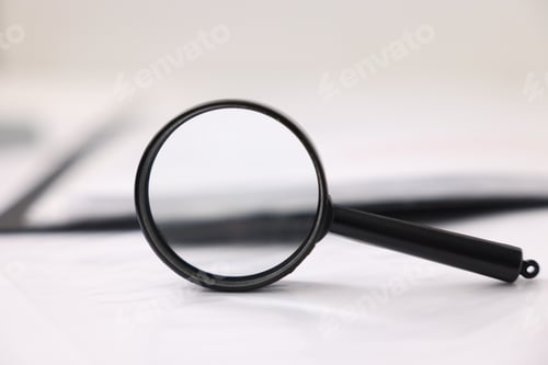 Preview: Magnifying glass and documents on table, closeup