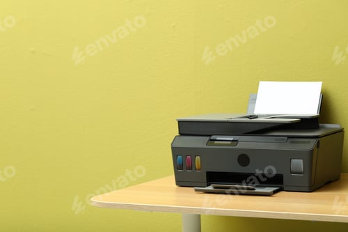 Preview: One black printer with sheet of paper on wooden table near green wall indoors. Space for text