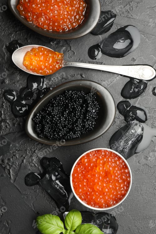 Preview: Delicious red and black caviar with basil, ice cubes on table, flat lay
