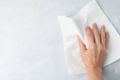 Vista previa: Woman wiping light grey surface with paper towel, top view. Space for text