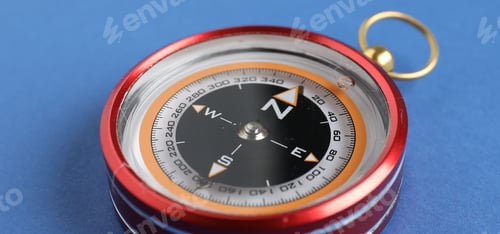 Preview: One compass on blue background, closeup view