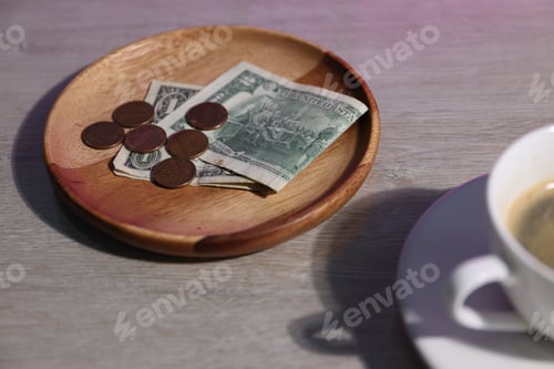 Preview: Tips and cup of coffee on light wooden table, closeup
