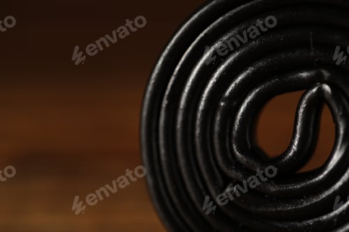 Preview: Licorice candy on brown background, closeup. Space for text
