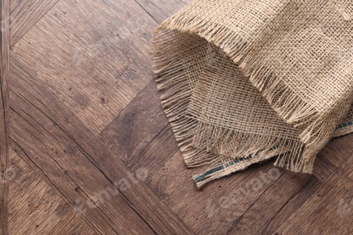 Preview: Natural burlap fabric on wooden table, top view. Space for text
