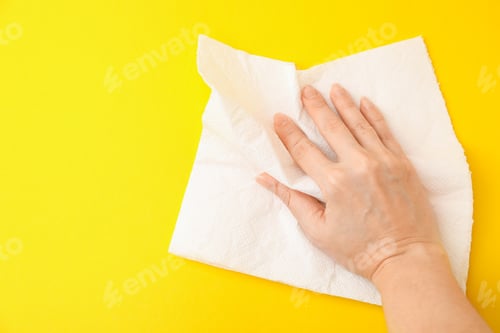 Vista previa: Woman with paper towel on yellow background, top view. Space for text