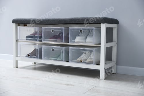 Preview: Storage bench with shoes in plastic boxes on floor near grey wall indoors