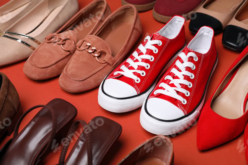Preview: Different beautiful shoes on coral background, closeup