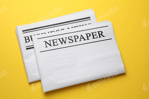 Preview: Folded newspapers on orange background, top view