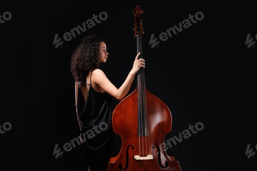 Preview: Woman with double bass on black background