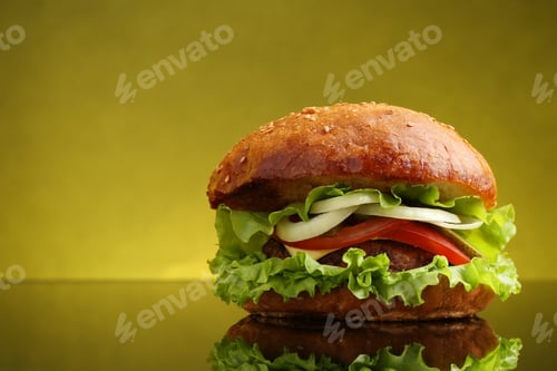 Preview: Delicious vegetarian burger on mirror surface against olive background, space for text
