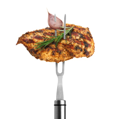 Preview: Carving fork with grilled chicken, rosemary and garlic isolated on white