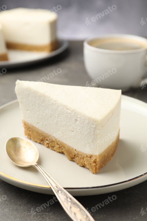 Preview: Piece of delicious cheesecake served on gray textured table, closeup