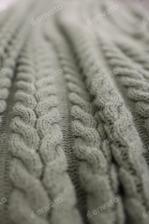 Vista previa: Soft knitted plaid as background, closeup view