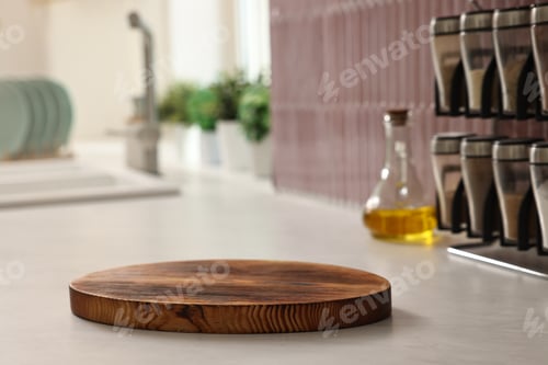 Preview: Wooden cutting board, spices and bottle of oil on countertop in kitchen, closeup
